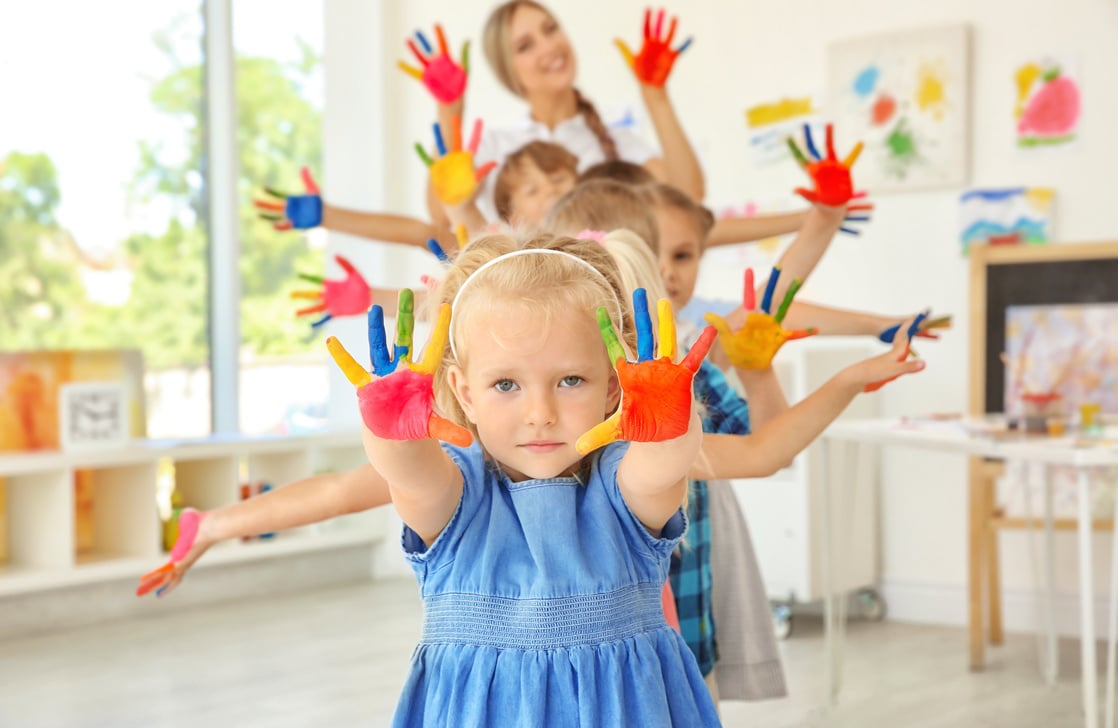 A Preschool Teacher with a Group of Children 